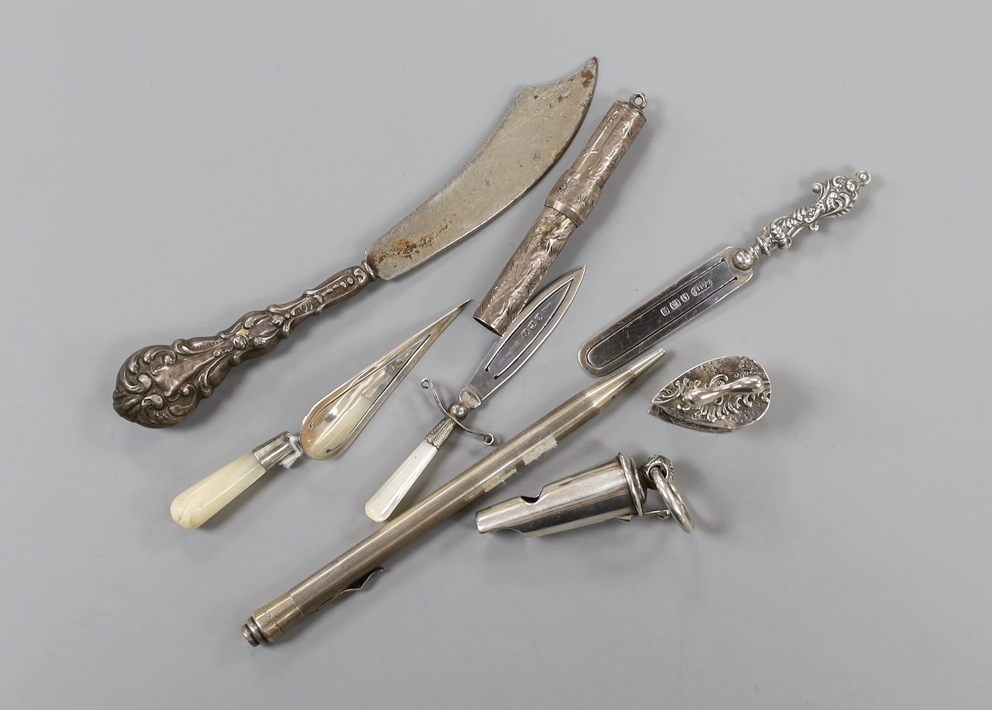 Collectable small silver including a Victorian silver whistle, London, 1859 (lacking outer case), three silver bookmarks, including trowel and dagger, a sterling pen, pencil case(no lead), silver handled scimitar paper k